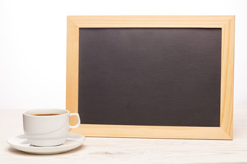 Blank board and cup of coffee.