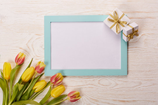 Blank sheet, gift and tulips.