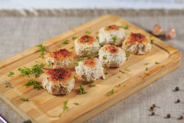 Chicken cutlets with greens on a gray background