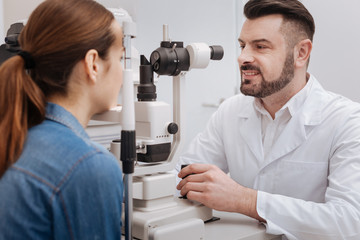 Handsome bearded doctor working with medical equipment