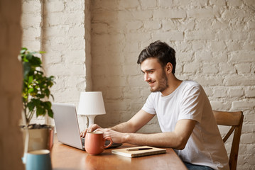 Attractive student use internet technology and high speed wi-fi connection to chat with friend....