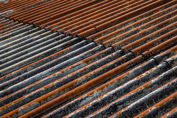 The old and rusty iron roof of a building