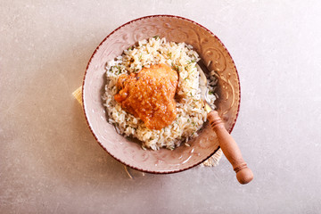 Herby rice with spicy chicken thigh in a bowl