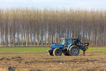 Blue Tractor in the Middle of a Field