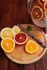 Citrus fruits sliced for lemonade and carafe