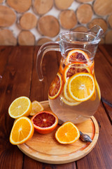 Citrus fruits sliced for lemonade and carafe