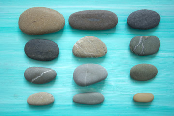 Fototapeta na wymiar sea pebbles pattern on a blue background.