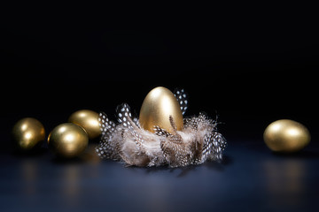 easter golden eggs on black background