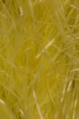 This is a photograph of Yellow shredded plastic fake Easter grass background