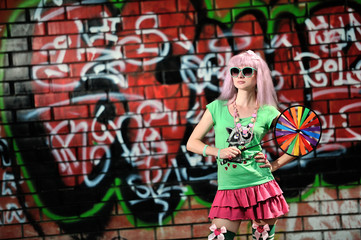Fototapeta na wymiar Girl on graffiti wall background