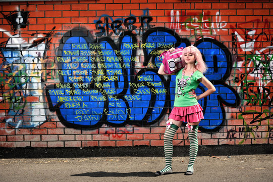 Girl on graffiti wall background
