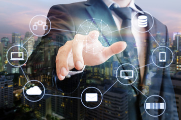 Double exposure of businessman touch on screen connected devices with world digital technology internet and wireless network and city of business background in business and technology concept
