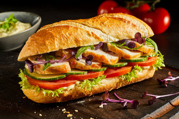 Sliced chicken breast and salad baguette - obrazy, fototapety, plakaty