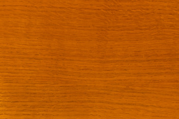 The texture of wood, oak, varnished. Red, orange.