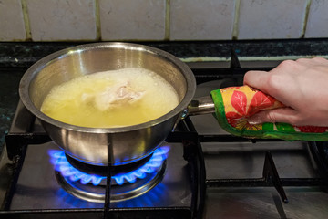 Cooking chicken broth on gas stove