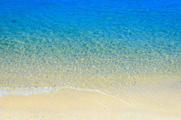 Soft wave of the blue sea on the sandy beach