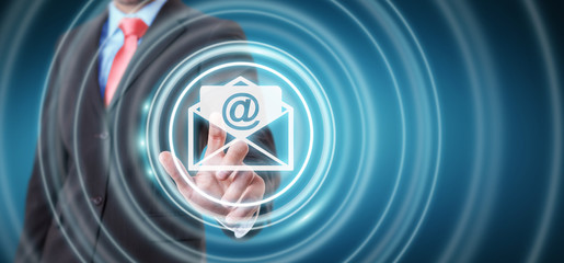 Businessman touching 3D rendering flying email icon with his finger