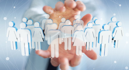 Businessman holding 3D rendering group of people in his hand