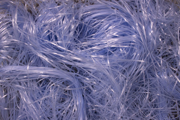 This is a photograph of Blue shredded plastic fake Easter grass background