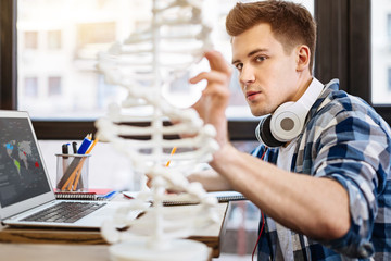 Smart diligent student studying genetics