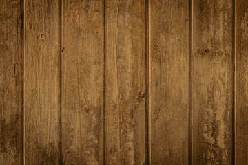 Wood texture in warm golden and brown tones. Old rural wooden wall, detailed plank fence photo background. Natural wooden building structure.