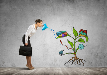 Young businesswoman in empty room watering drawn growth concept with can