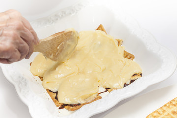 Fototapeta na wymiar Napoleon dessert preparation : Adding custard cream