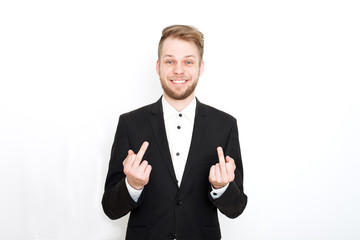 Young attractive man in a black suit showing middle finger on a white background. Isolated