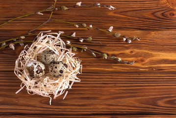 Easter decoration, Easter eggs in the nest on brown wooden background.