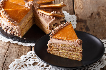 Homemade slice of Hungarian Dobosh cake with caramel close-up. horizontal