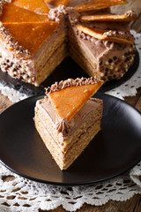 piece of Hungarian Dobos cake with caramel close-up. vertical