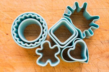 plastic baking mold set of blue different shape forms, isolated over the wooden background