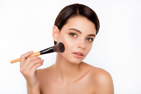 Portrait of young beautiful woman holding the makeup brush