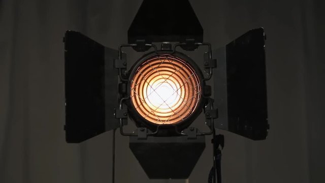 Footage of studio light being turned on and off. Floodlight flashes