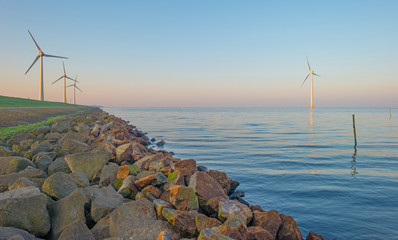 Dike along a lake at sunrise in spring