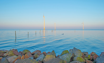 Wind turbines in a lake at sunrise
