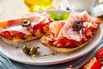 Fried tostada with salsa and prosciutto