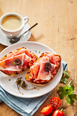 Gourmet tostada snacks with prosciutto ham