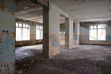 Fototapeta na wymiar Abandoned empty Soviet construction with windows