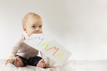 Funny little boy with poster in his mouth. Idea for Mothers day postcard. Copy space