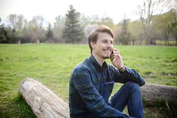 .Handsome guy talking on the phone in the park