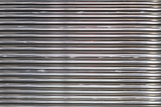 Background image of a texture of a metal undulating surface