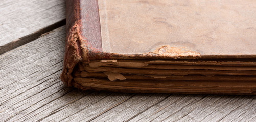 Detail of an old book on a wooden table