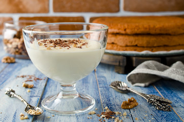 Yogurt cream for cake with chocolate and nut crumbs.