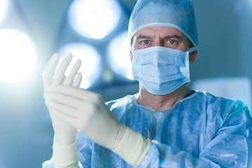 Serious male doctor dressed in special uniform