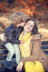 Fototapeta premium Small boy kissing his mother.