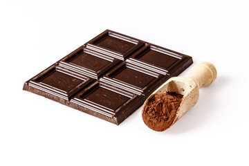 wooden spoon with coacoa or cacao and chocolate on white