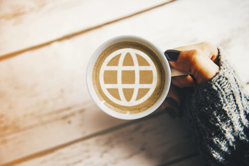 Girl with a cup of coffee with a world globe symbol