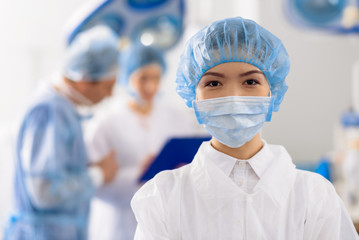 Happy nurse in sterile mask