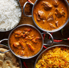 assortment of indian curry and rice dishes shot from overhead composition